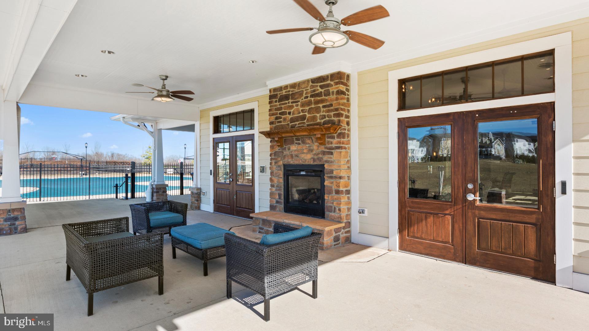 830 Reagans Road Frederick, MD 21702 - Photo 22 of 23 a living room with furniture a fireplace and a floor to ceiling window