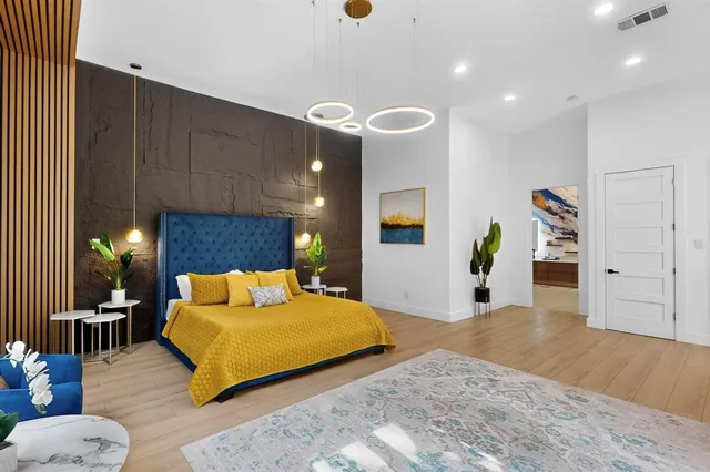 a bedroom with furniture and a wooden floor