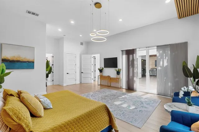 a bed room with a bed mirror and a television