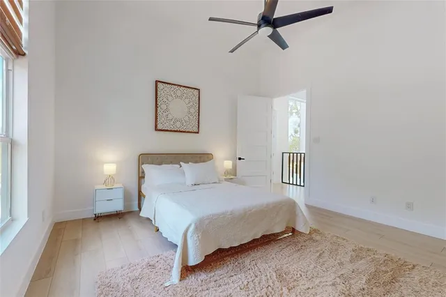 a bedroom with a bed and painting on the wall