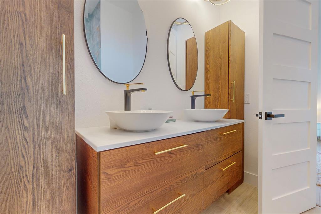 3946 North Cresthaven Road Dallas, TX 75209 - Photo 21 of 39 a bathroom with a sink and a mirror