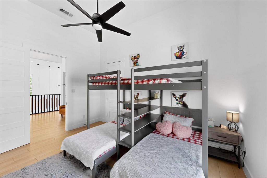 3946 North Cresthaven Road Dallas, TX 75209 - Photo 23 of 39 a bedroom with a bed and a chandelier