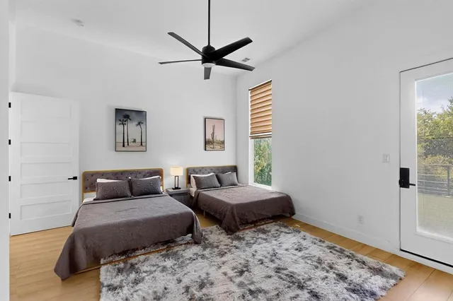 a bedroom with two beds and a dresser