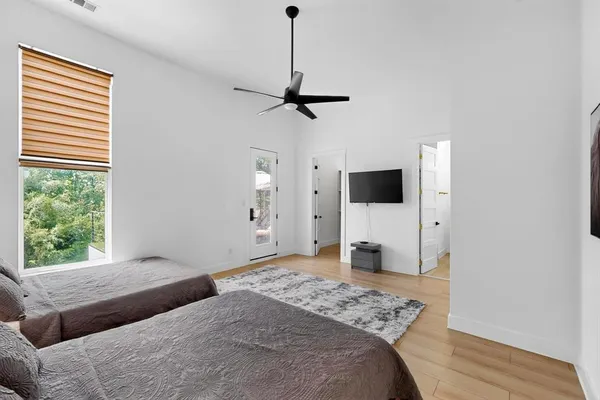 a bedroom with a bed and a flat screen tv