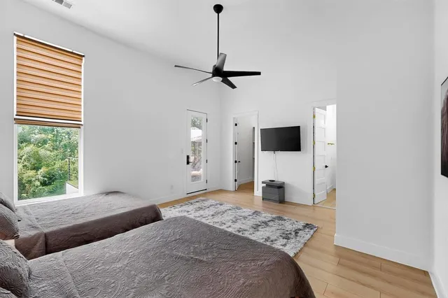 a bedroom with a bed and a flat screen tv