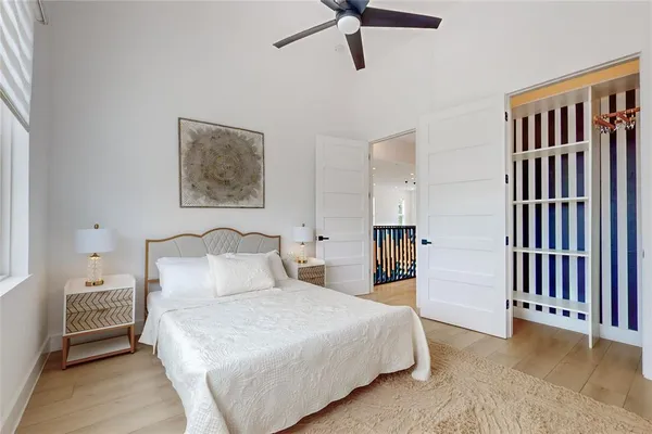 a bedroom with a bed and a chandelier