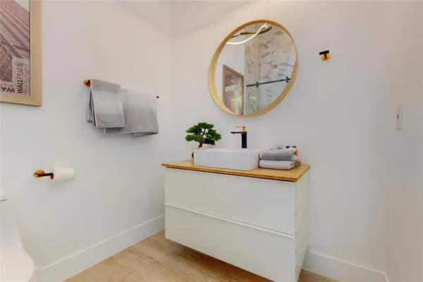 a bathroom with a sink mirror and vanity