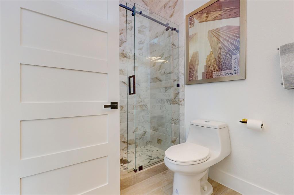 3946 North Cresthaven Road Dallas, TX 75209 - Photo 29 of 39 a bathroom with a toilet and a shower