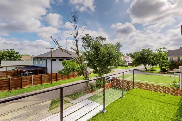 a view of a terrace with chairs and wooden fence