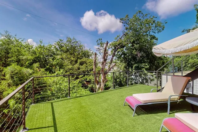 a backyard of a house with table and chairs