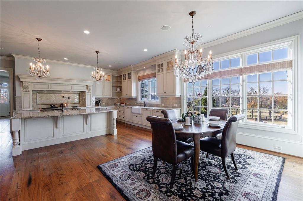 15750 Freemanville Road Milton, GA 30004 - Photo 14 of 30 a view of a dining room with furniture window and wooden floor