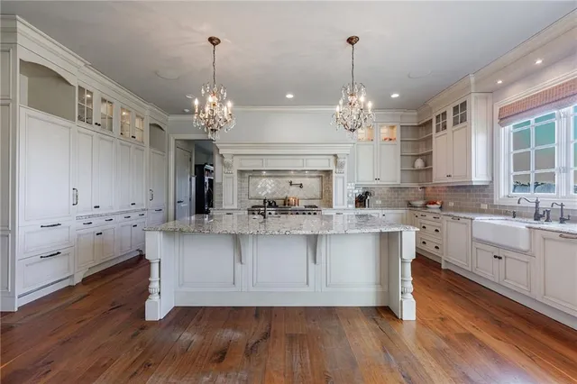 a kitchen with stainless steel appliances white cabinets and a stove