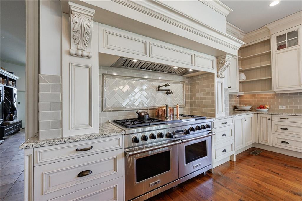 15750 Freemanville Road Milton, GA 30004 - Photo 18 of 30 a kitchen with stainless steel appliances white cabinets and a stove
