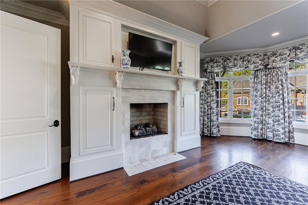 15750 Freemanville Road Milton, GA 30004 - Photo 23 of 30 a living room with a flat screen tv and a fireplace