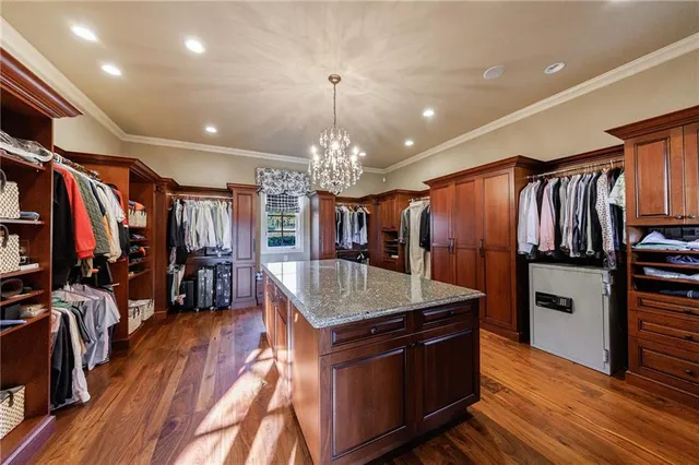 a kitchen with stainless steel appliances granite countertop a refrigerator a stove and a wooden floors