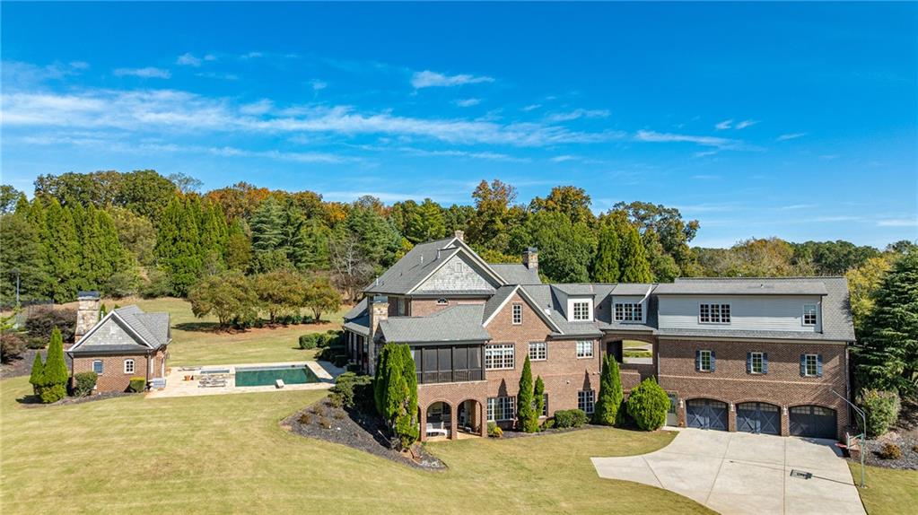 15750 Freemanville Road Milton, GA 30004 - Photo 9 of 30 a front view of a house with a yard and garage