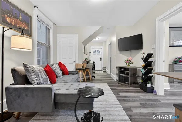 a living room with furniture and a flat screen tv