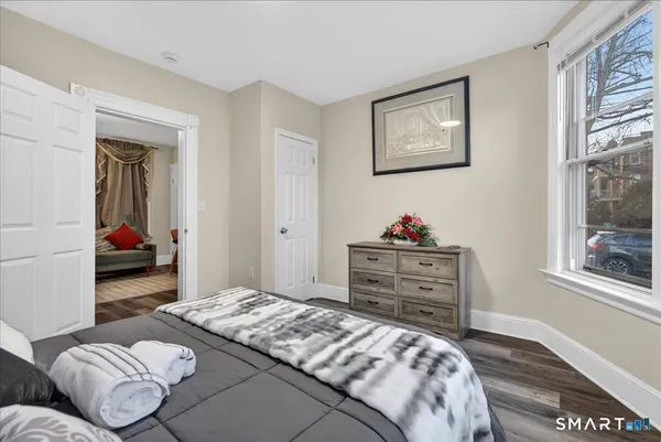 a bedroom with a bed and a window