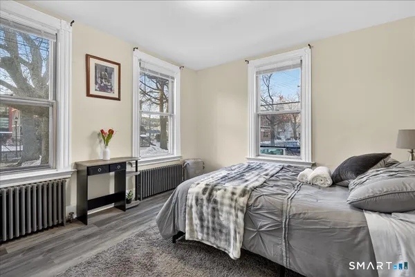 a bedroom with a bed and a window