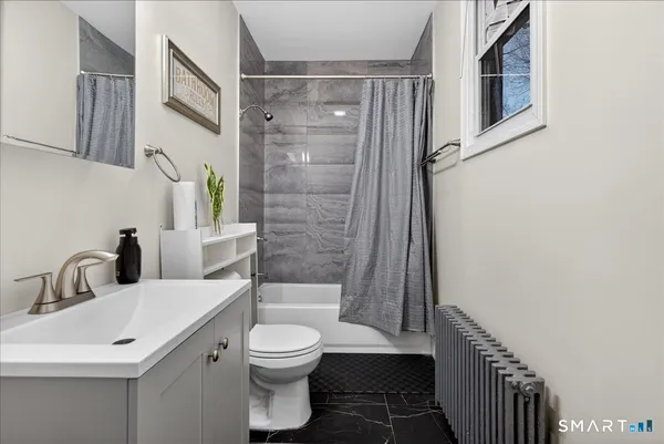 a bathroom with a toilet sink and shower