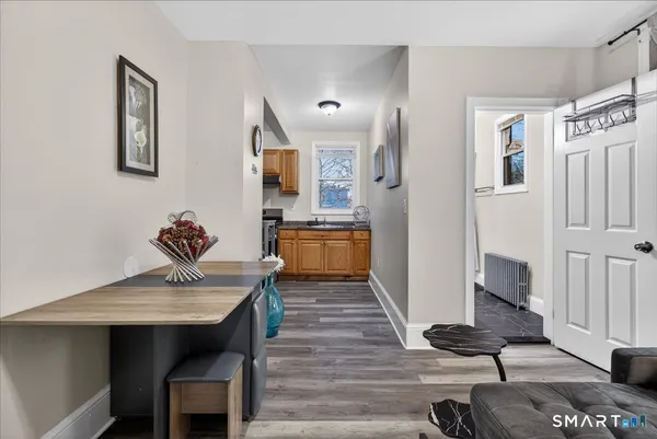a view of a dining room with furniture wooden floor and a kitchen
