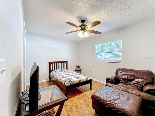 a bedroom with furniture and a window