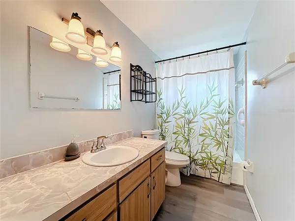 a bedroom with a bed and a large mirror