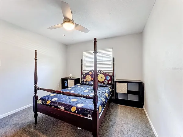 a bedroom with a bed and a television