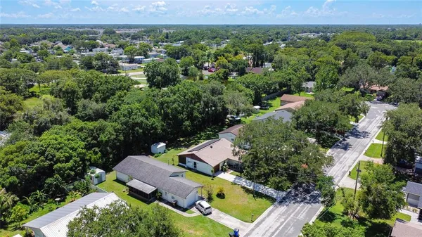 an aerial view of residential houses with outdoor space and swimming pool