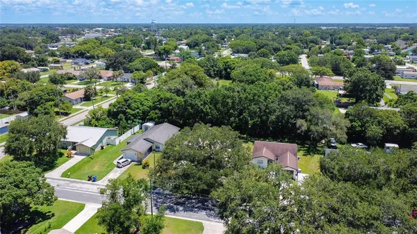 an aerial view of a house with a yard