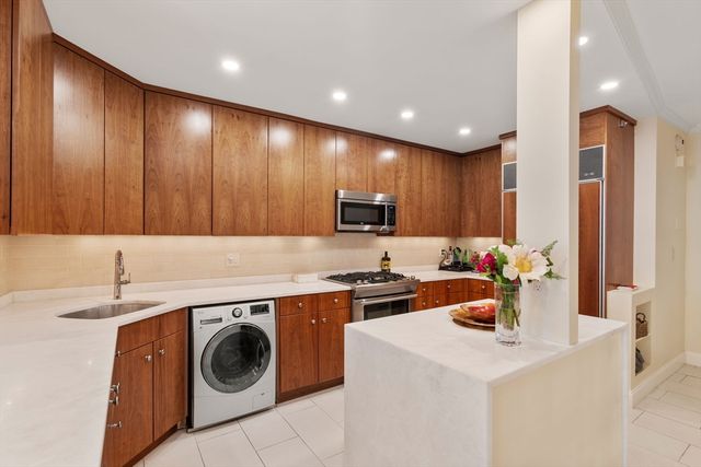 a kitchen with a sink a stove and cabinets