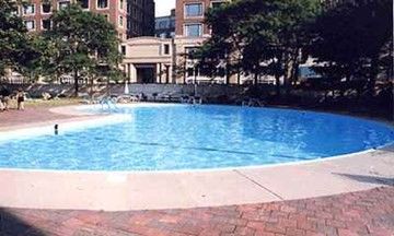a view of a patio with a dining table and chairs with a small yard