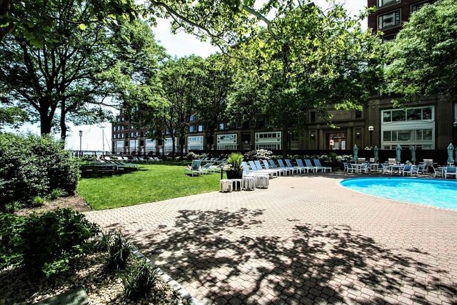 a view of swimming pool with a backyard and slide