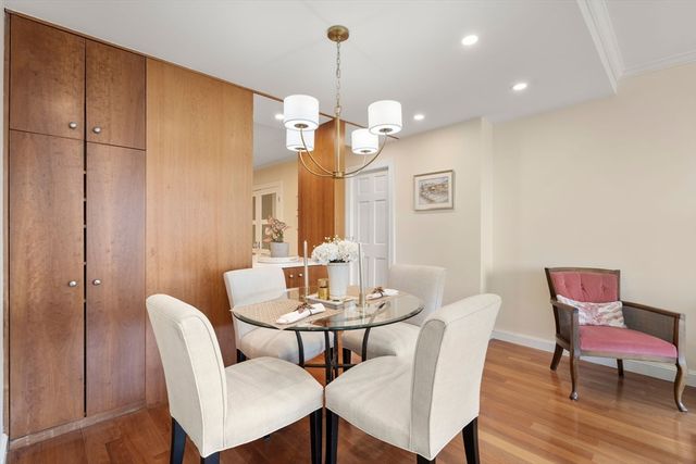 a dining room with furniture and wooden floor