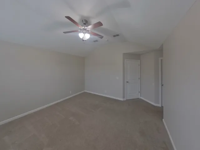 a view of an empty room with a fan