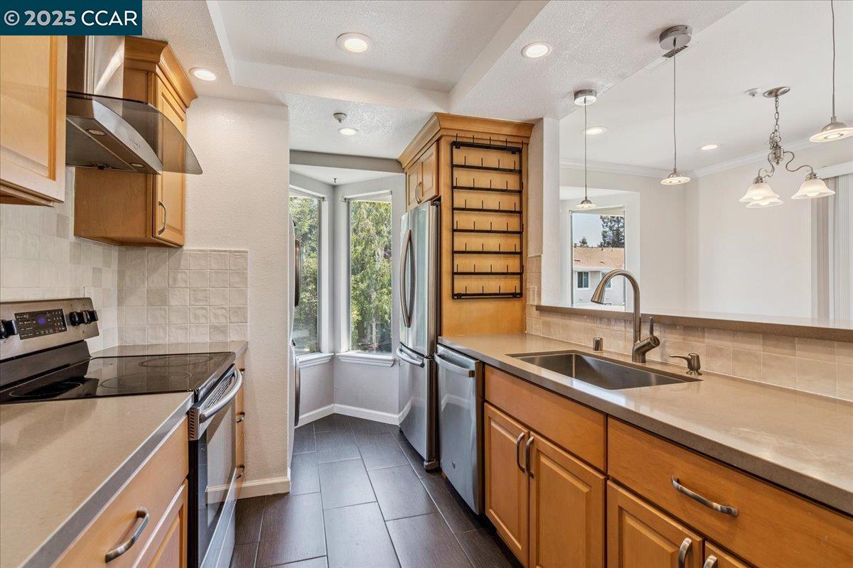 a kitchen that has a sink and a stove