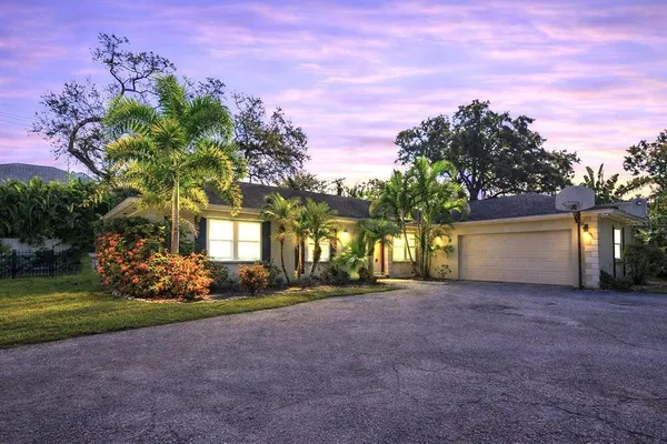a view of a house with a yard and garage