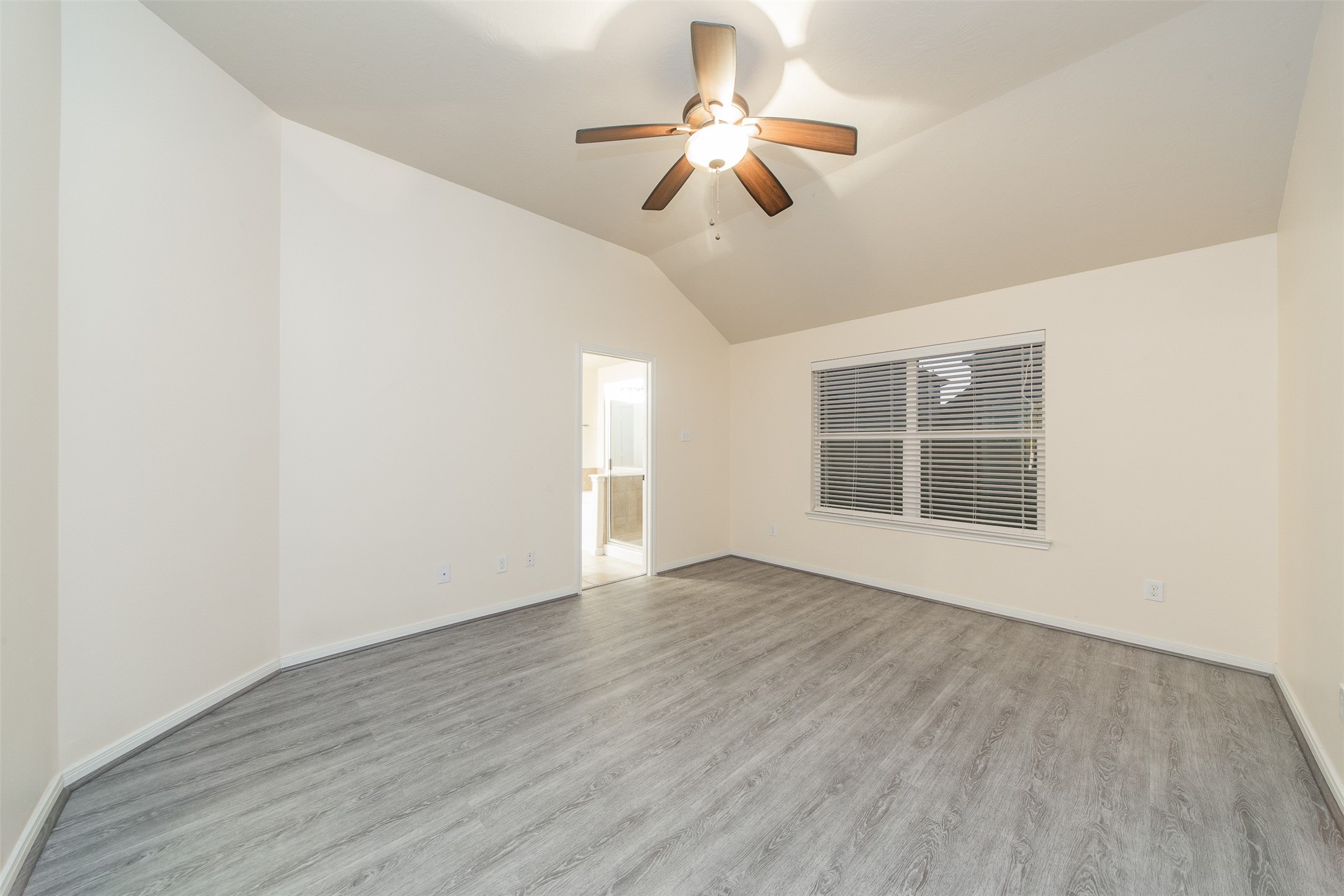 3418 Lily Ranch Drive Katy, TX 77494 - Photo 14 of 24 a view of an empty room with a window and wooden floor