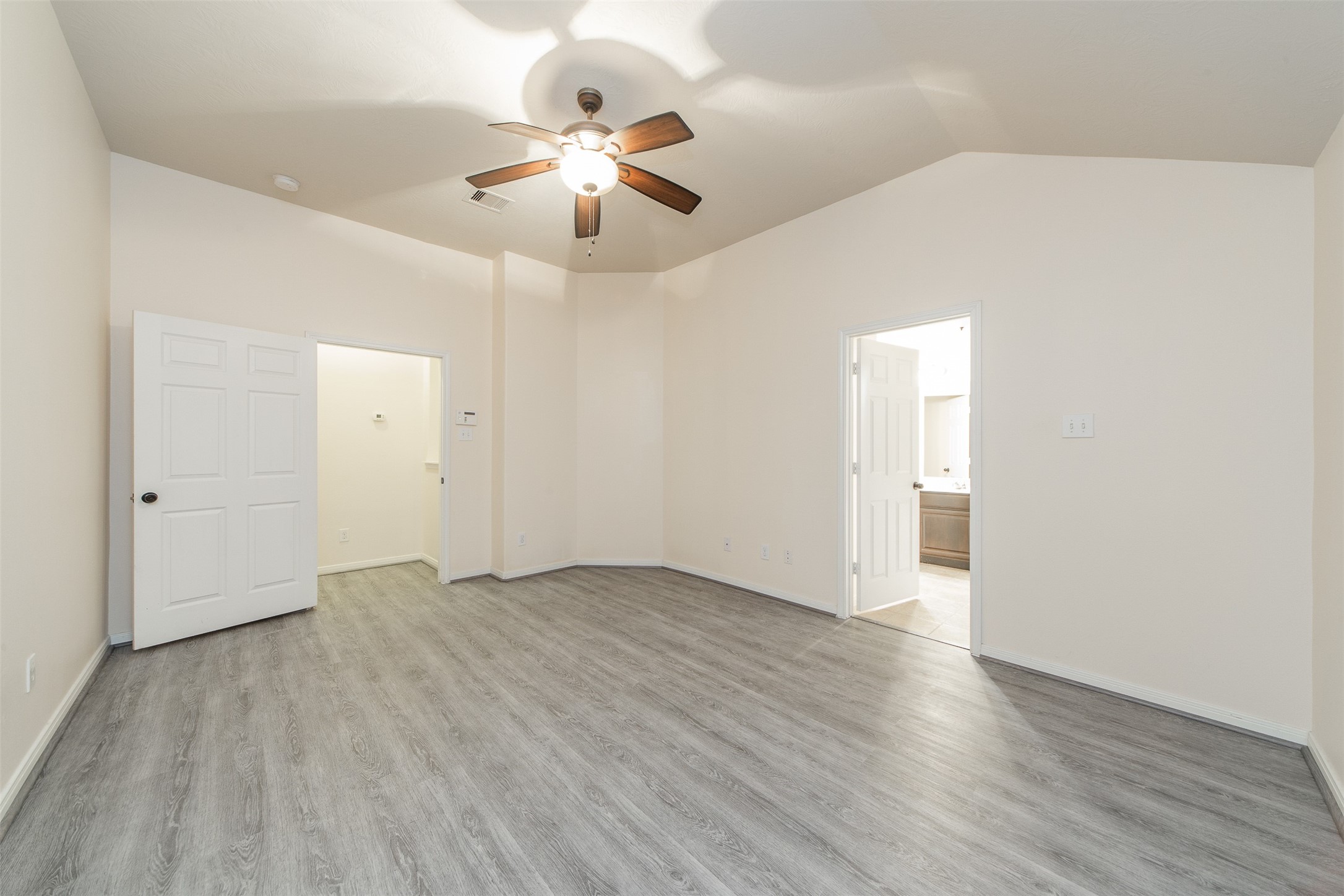 3418 Lily Ranch Drive Katy, TX 77494 - Photo 15 of 24 an empty room with wooden floor chandelier fan and closet area