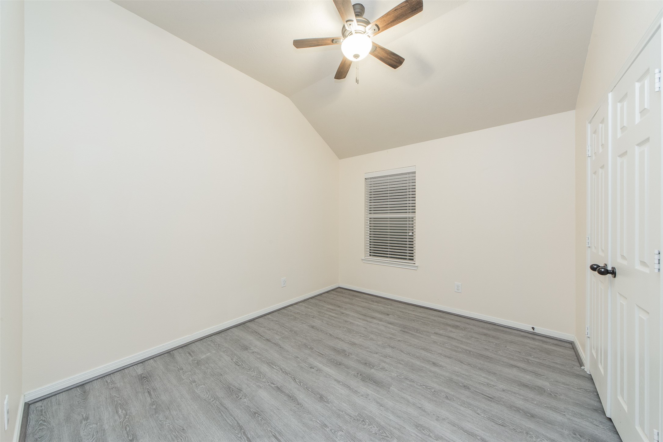 3418 Lily Ranch Drive Katy, TX 77494 - Photo 20 of 24 an empty room with wooden floor fan and windows