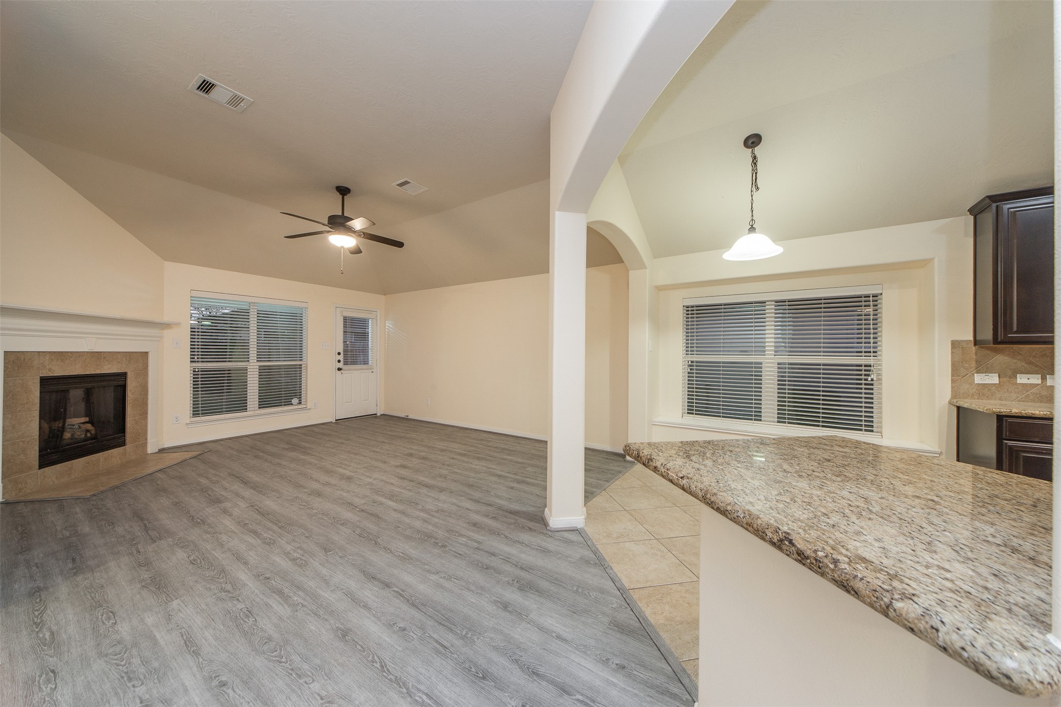 3418 Lily Ranch Drive Katy, TX 77494 - Photo 6 of 24 a view of an empty room with a kitchen and a window