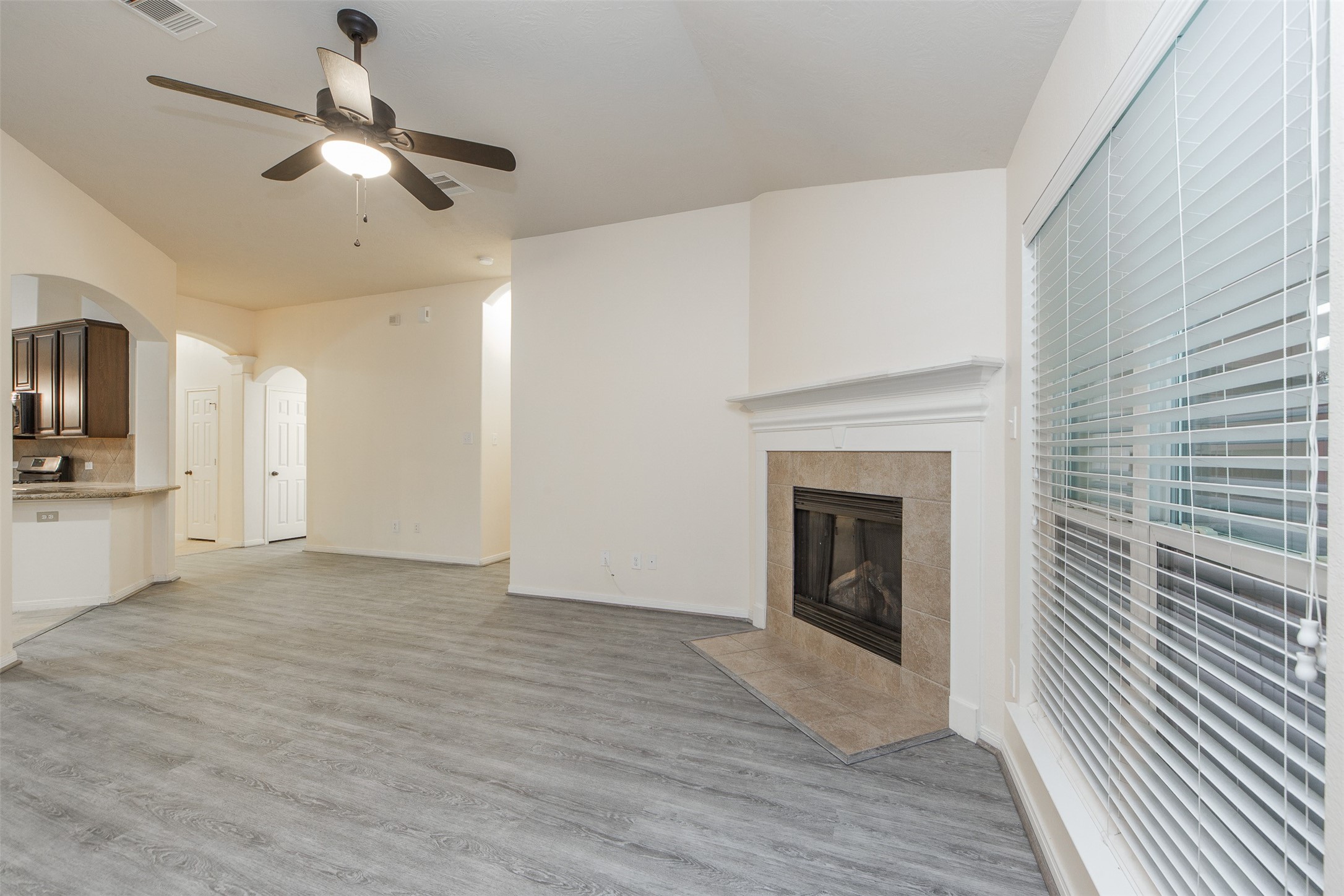 3418 Lily Ranch Drive Katy, TX 77494 - Photo 8 of 24 a view of a livingroom with a fireplace a ceiling fan and wooden floor