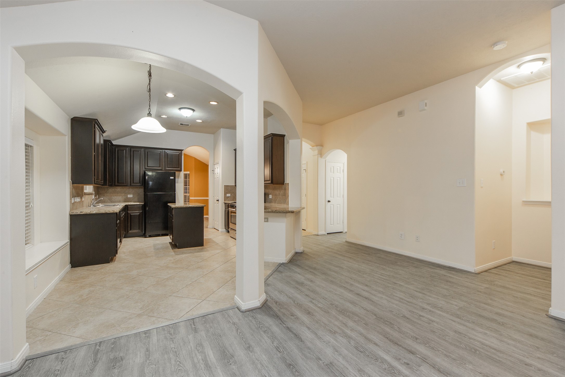 3418 Lily Ranch Drive Katy, TX 77494 - Photo 9 of 24 a view of a kitchen with refrigerator and wooden floor