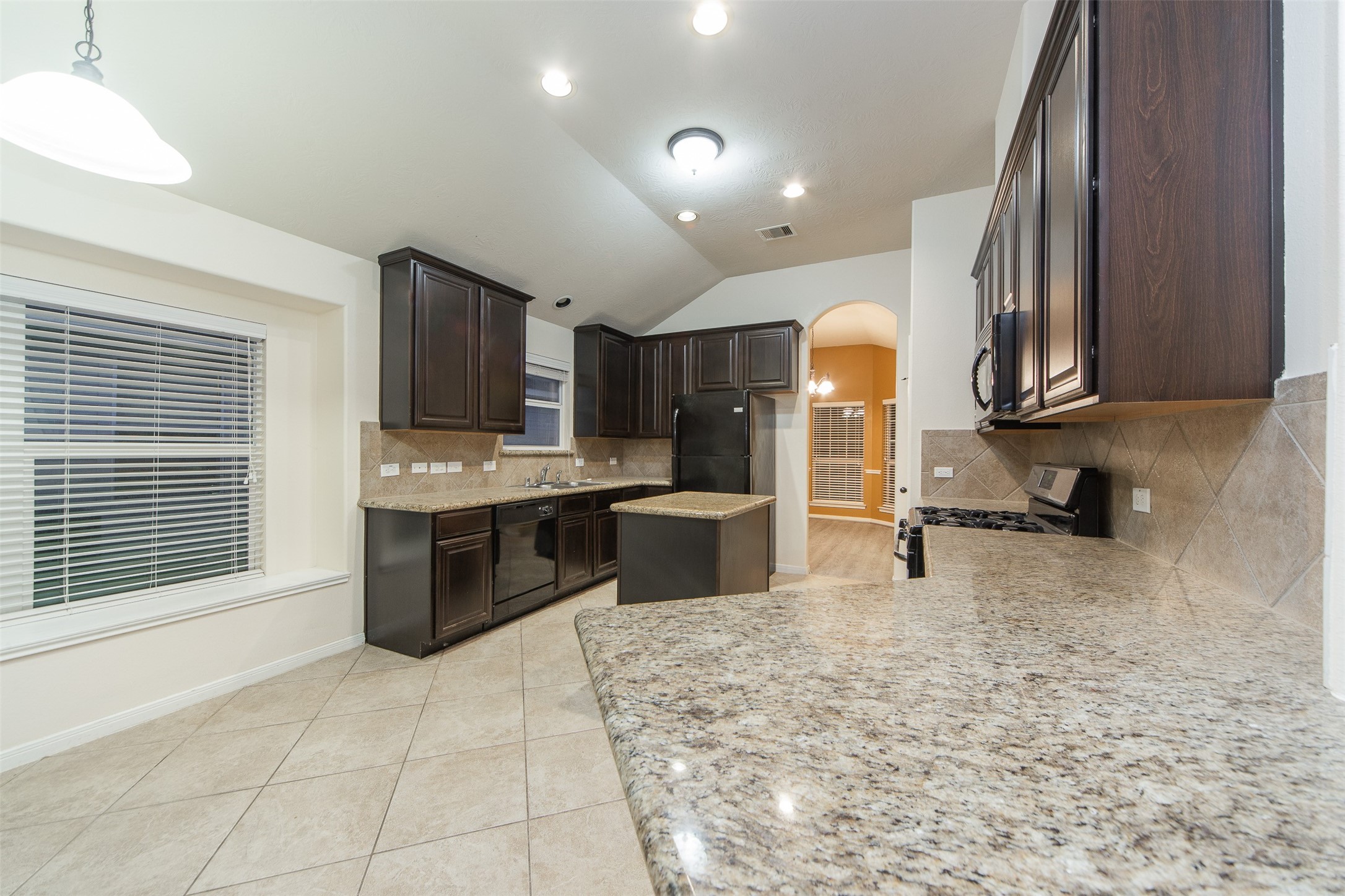 3418 Lily Ranch Drive Katy, TX 77494 - Photo 10 of 24 a kitchen with stainless steel appliances a refrigerator sink and cabinets