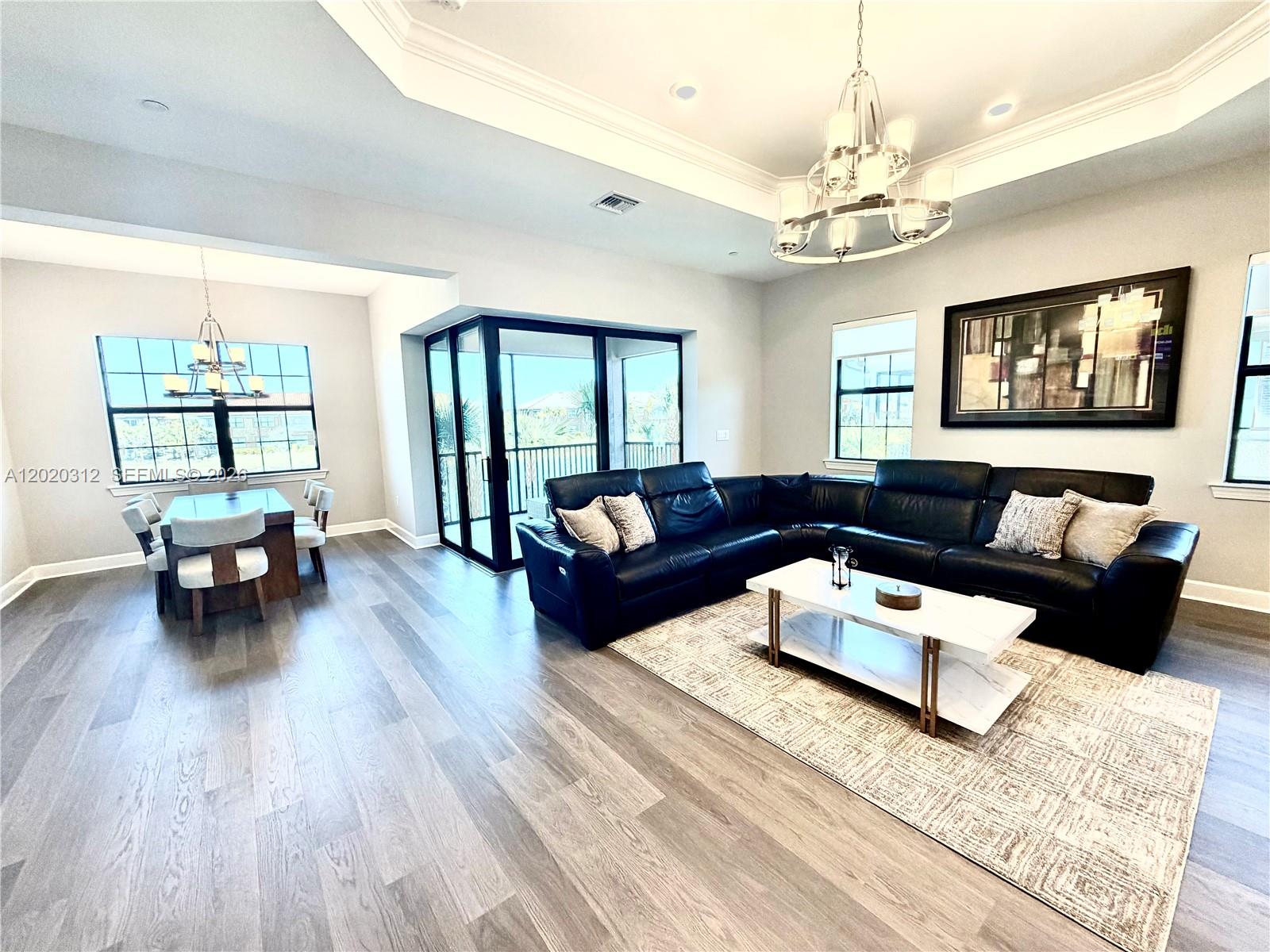 15323 Lucerna Street, Unit 204 Naples, FL 34114 - Photo 9 of 29 a living room with furniture and a wooden floor