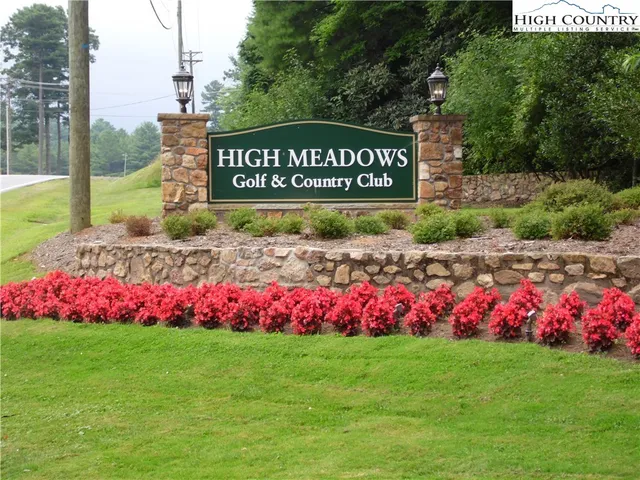a street sign in front of flowers