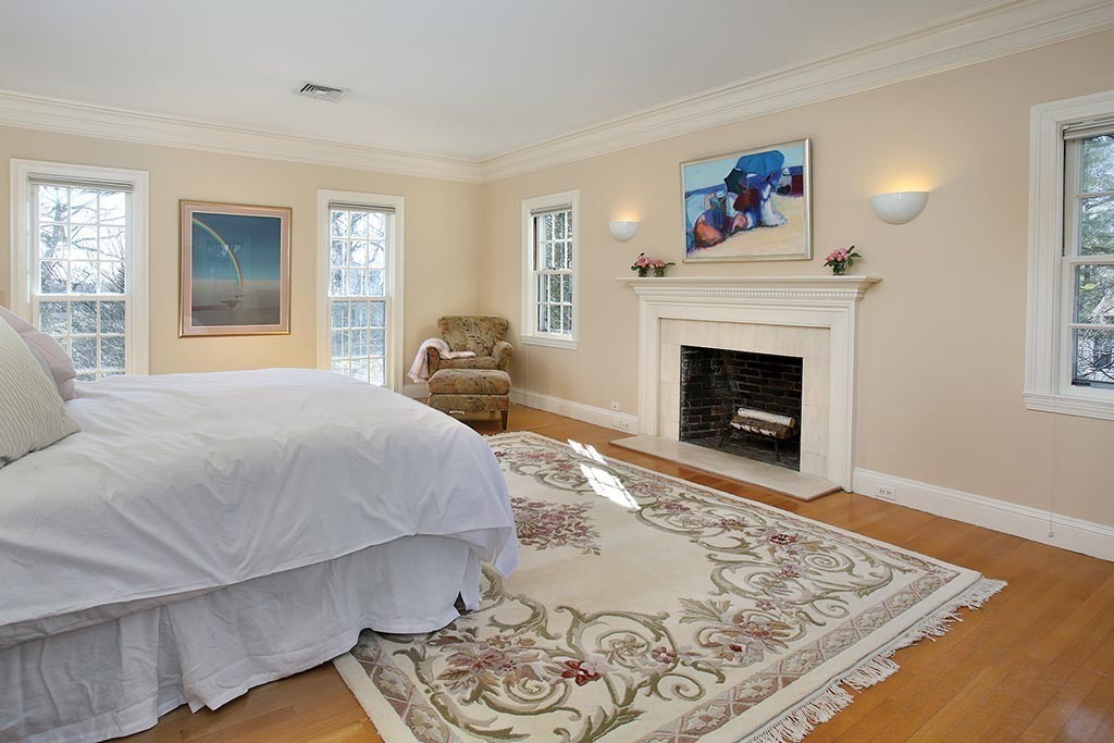 24 Estabrook Road Newton, MA 02465 - Photo 12 of 15 a spacious bedroom with a bed and a fireplace