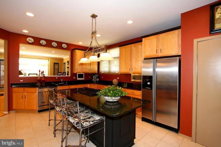1441 Waterfront Road Reston, VA 20194 - Photo 12 of 30 a kitchen with stainless steel appliances kitchen island granite countertop a table and chairs