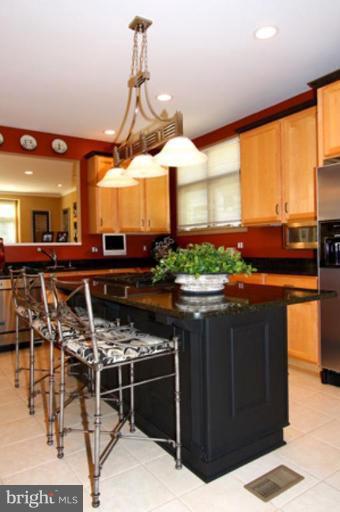 1441 Waterfront Road Reston, VA 20194 - Photo 13 of 30 a kitchen with stainless steel appliances granite countertop a stove a sink and a microwave