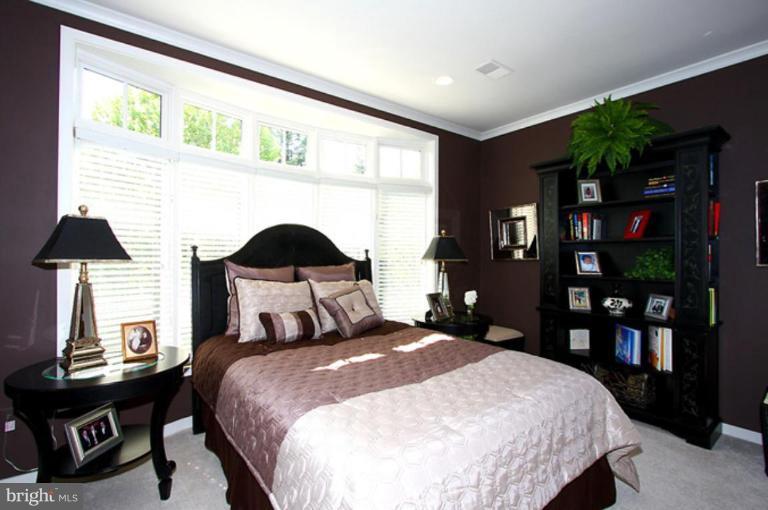 1441 Waterfront Road Reston, VA 20194 - Photo 18 of 30 a bedroom with a bed a table and a large window